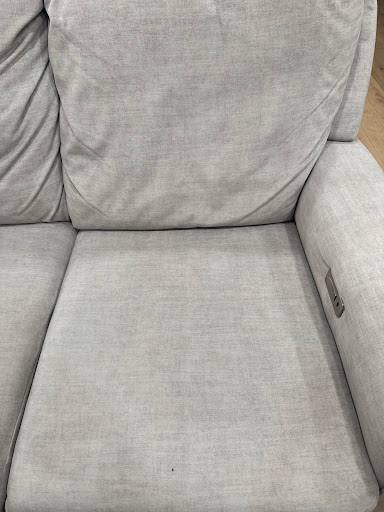 The same light grey fabric sofa after cleaning, the seat even in color