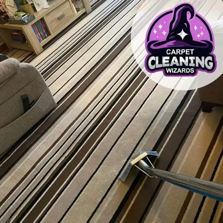 Striped wool rug during hot water extraction, the wand halfway across, by Carpet Cleaning Wizards