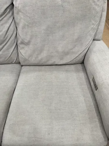 The same fabric sofa after cleaning, the fabric brightened and the cushions freshened