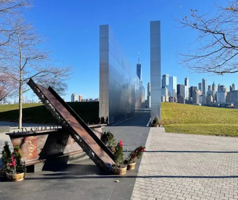 Panoramic view from Liberty State Park showing memorial sculptures and the New York City skyline in the background, offering a space for reflection and recreation.